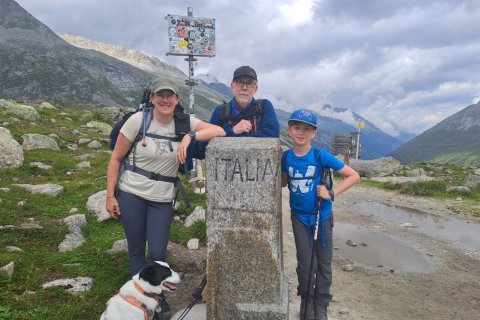 Die Dozentin mit Sohn und Ehemann an einem Grenzstein nach Italien in den Alpen.